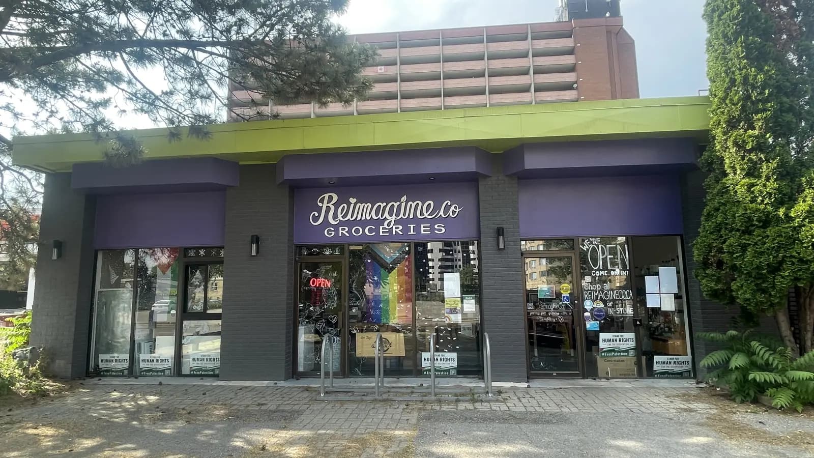 206 Piccadilly from the street: the purple and green Reimagine Co Groceries shopfront
